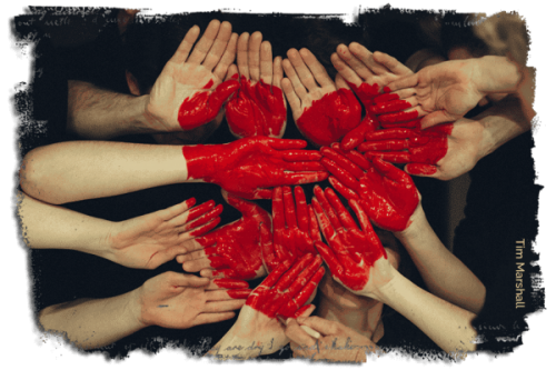 Giving Back image of hands with heart painted across hands